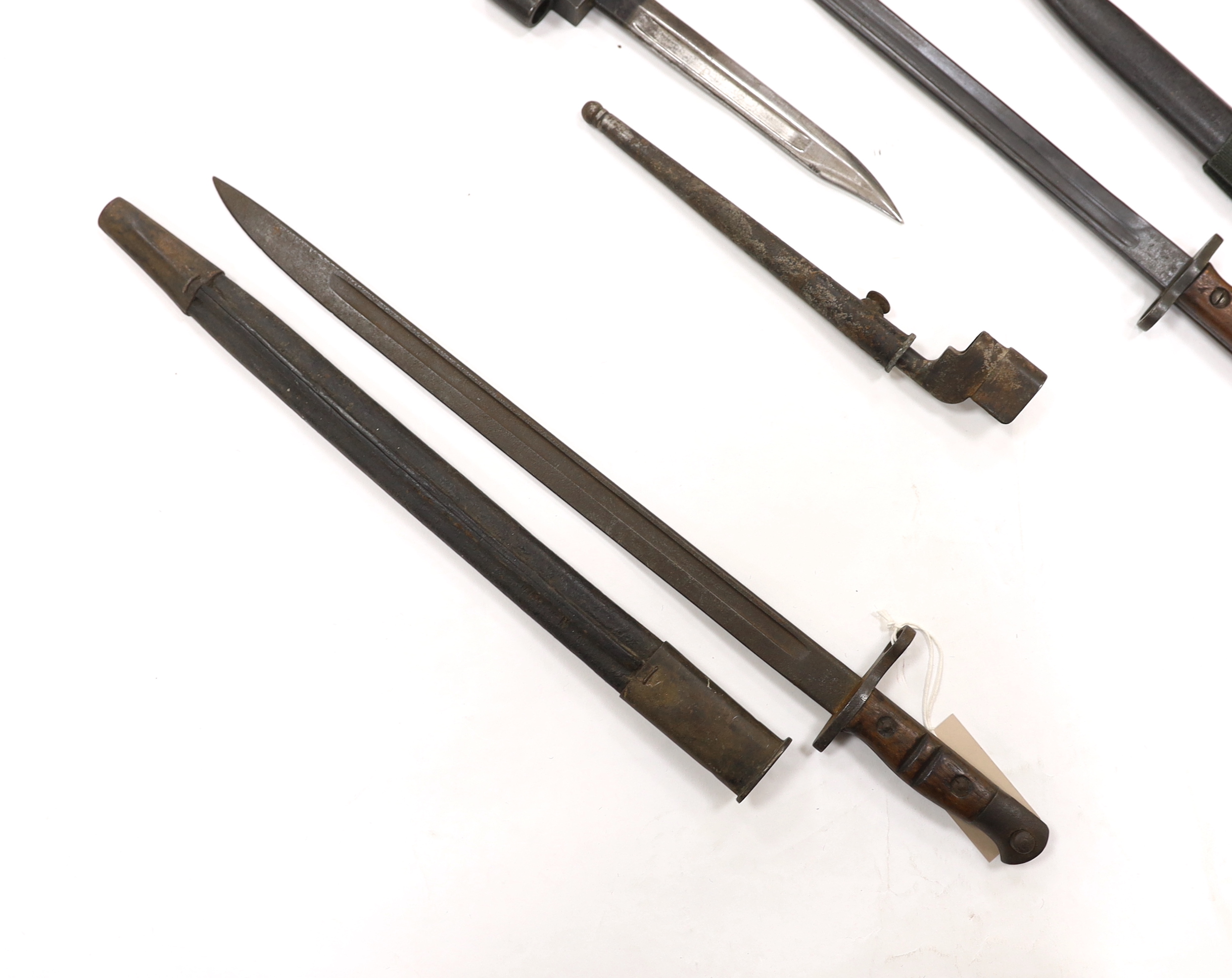 Six bayonets; an American Remington bayonet dated 1917 in its leather scabbard, a British 1907 bayonet with scabbard missing, and four assorted spike bayonets